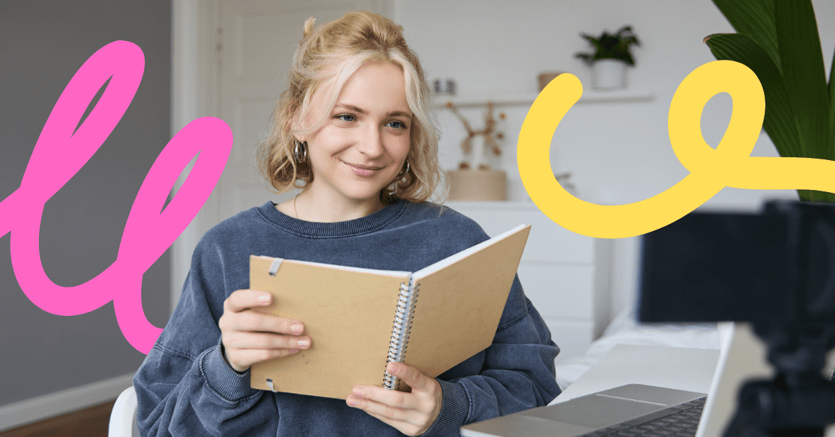 a woman with blonde hair looking at a book in front of laptop